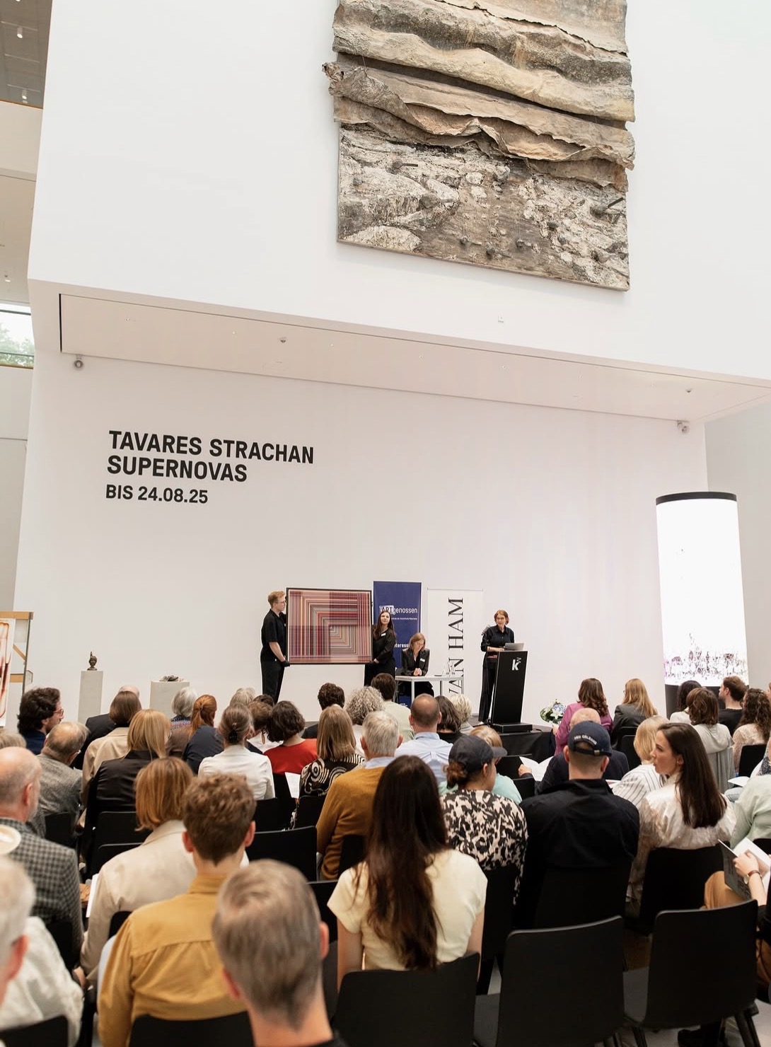 A thread work presented on stage during the auction at Kunsthalle Mannheim