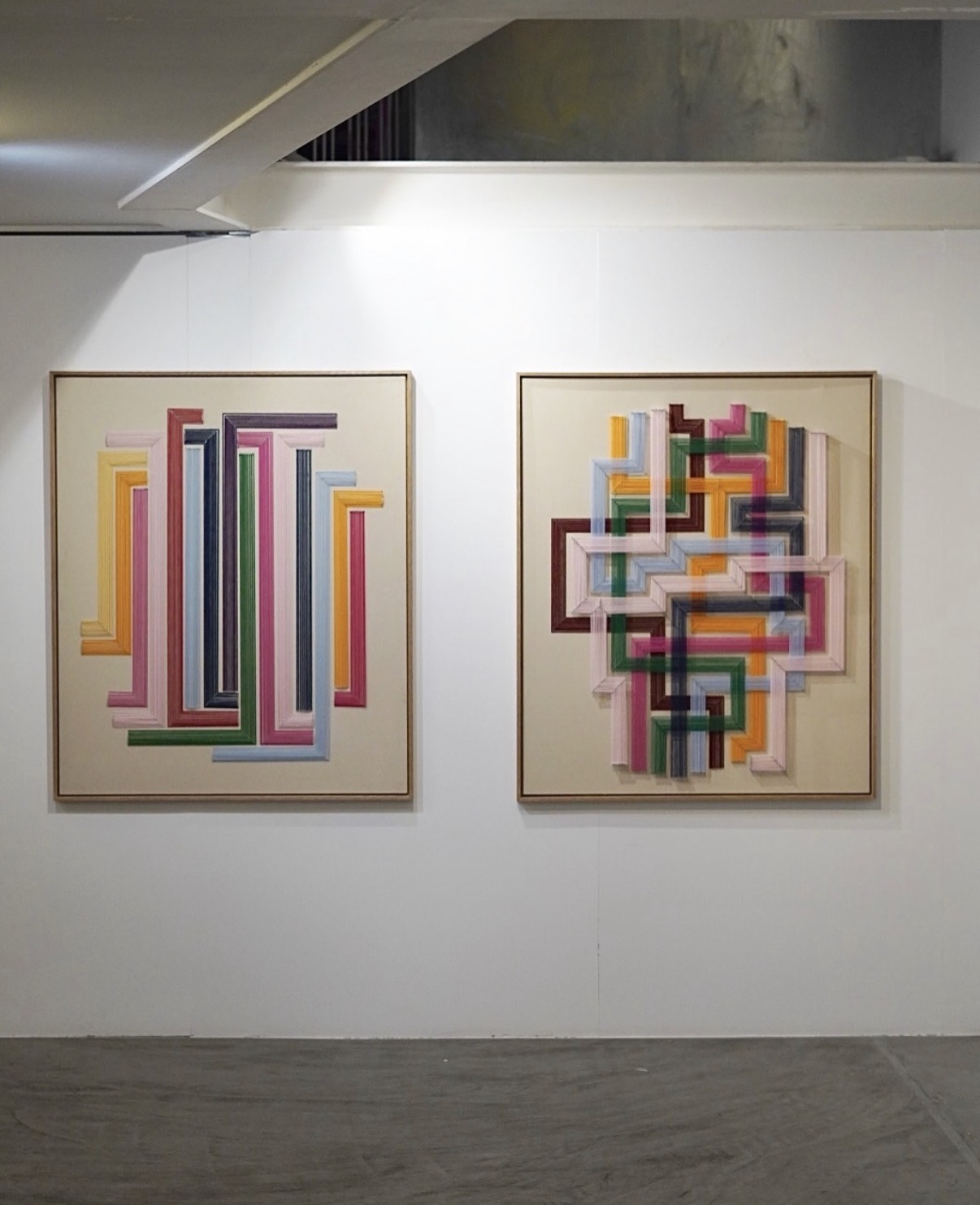 Two large colourful thread works installed side by side at WitArt Gallery in Madrid
